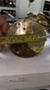 Close-up measurement of brass cabinet pull backplate base for mounting and hardware fit reference