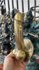 Handheld view of 6 inch brass penis cabinet pull in gold finish, cheeky statement hardware for cabinets and drawers