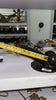 Tape measure photo showing length of brass penis door pull handle for sizing and installation planning.