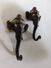 two pieces of antique brass ganesha elephant head wall hooj jewlery holder mounted to the white wall