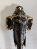 Decorative elephant head sculpture with gold accents on a white background