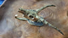 Brass Gold Impala skeleton head hook on wooden table