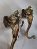 A pair of brass elephant-shaped wall hooks with intricate designs, displaying a golden finish.