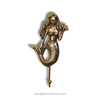 Hollow brass mermaid wall hook used as a light towel hanger in a coastal bathroom