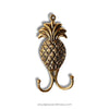 Brass pineapple hook on a white background