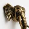 Detailed elephant trunk brass door pull close view, handcrafted Bali artisan decor, statement door hardware, brass elephant door handle set and unique housewarming gift