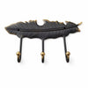 Antique brass feather 3-hook wall rack on a white background, with a dark aged finish and three ball-tipped hooks beneath a long carved feather. Handmade cast brass coat rack for entryways, bathrooms and bedrooms, hand-finished by artisans in Ubud, Bali.