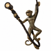 Antique brass monkey wall lamp on a white background, showing the aged bronze finish, textured fur detail, gold-tipped hands and feet, round wall plate and spotlight. The antique brass option of this handmade plug-in monkey sconce from Ubud, Bali.