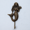 Antique finish brass starfish mermaid wall hook, showing the detailed mermaid engraving and coastal design. brass