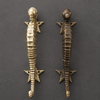 Pair of antique bronze seahorse door handles on dark background, weathered nautical finish