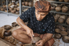 Bali artisan hand-carving coconut shell planters