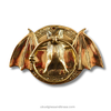 Gold bat-shaped decorative item on a white background