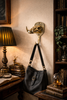 Brass boar skull hook holding a bag—gothic dark academia wall hook for entryway organization