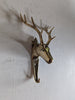gold brass deer with antlers wall hook mounted to the wall