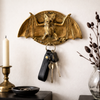 brass bat wall hook holding keys gothic home decor styling with candle aesthetic