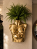 Brass female torso sculpture styled as wall planter in eclectic home decor, gold body sculpture for maximalist decor, artistic brass body art, luxury statement decor