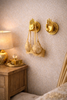 Gold brass Buddha mudra hand wall hooks holding robes in a cozy boho room (set of 2)