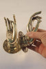 Size #2 brass Buddha mudra hand in gold finish shown in hand for scale as cabinet pull or wall hook.