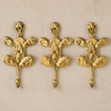 Set of 3 brass cactus wall hooks mounted in a row, shown as a boho coat hook set and desert-style wall decor made from solid brass.