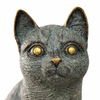 Close up of brass cat sculpture face detail showing textured surface and aged patina