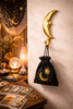 Brass crescent moon wall hook styled in a tarot reading room with astrology decor, crystals, candles, and celestial accents