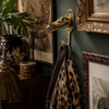 Brass crocodile skull wall hook styled in a dark academia maximalist interior with ornate gold frames and leopard print scarf hanging — gothic animal wall hook handmade in Ubud Bali