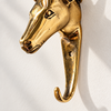 Close-up side profile of the gold brass deer head hook, showing the detailed muzzle, eye and the smooth curved hook below. A handmade brass deer hook and deer lover gift, cast in Bali.