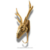 Gold deer head sculpture on a white background