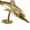 Gold brass dolphin door handle side angle showing sculpted details, nautical door hardware.