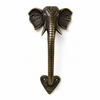 Full length solid brass elephant trunk door handle in rich dark antique patina finish on white background showing complete product from detailed elephant head with large ears and curved tusks at top through coiled segmented trunk body to ornate heart shaped base plate at bottom. Dark aged brass patina with warm highlighted texture areas visible on raised surfaces. Handcrafted unique elephant door pull and antique entry door handle for boho home decor and housewarming gift. Made in Bali.
