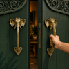 Brass elephant trunk door handle set of 2 installed on double entry doors, handcrafted Bali elephant door pull, antique brass hardware, statement double door handle set for boho home decor, grand entrance hardware and housewarming gift