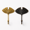 Side by side comparison of brass fan leaf wall hooks showing warm gold finish and rich dark antique finish options on white background. Handcrafted leaf shaped plant hanger hook, towel hook and coat hook for boho home decor, dark academia decor and housewarming gift. Available in gold and dark antique finish — select at checkout