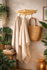 Brass feather coat hook rack with 3 hooks styled in an entryway for towels, robes, bags, and everyday storage