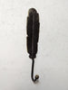 Antique brass feather wall hook mounted on wall