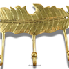 Close-up of brass feather wall hook rack texture, decorative leaf design with 3 hooks for home organization