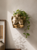 Small brass female torso sculpture used as a wall planter with trailing greenery — gold body art for boudoir decor and eclectic home decor, unique housewarming gift for him and her