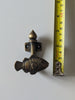 Brass fish wall hook next to measuring tape showing size for coastal bathroom or nursery decor