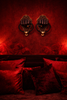Brass fist wall sculptures styled in intimate red interior, provocative yet tasteful after dark statement wall decor