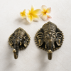 Back view of brass Ganesha wall hook showing single mounting hole and solid brass construction for easy wall installation. Handcrafted Buddhist elephant wall hook for boho home decor, yoga room decor, meditation space and housewarming gift. Created with reverence by professional Hindu artisans in Bali. Available in small and large size and gold and antique finish