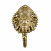 Gold polished brass Ganesha wall hook on white background showing complete ornate Ganesha sculpture, intricate crown detail, detailed face and warm bright gold brass finish with trunk hook. Handcrafted Buddhist elephant wall hook for boho home decor, yoga room decor and housewarming gift. Created with reverence by professional Hindu artisans in Bali. Available in antique finish too.