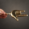 Hand holding a brass hand gesture wall hook, showing the sign of the horns design from the heavy metal decor collection.