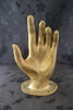 Gold-finish brass hand wall sculpture shown from the front.