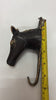 Brass horse wall hook measured with tape for size reference, sturdy horse head hook for tack room and entryway.