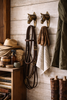 Brass horse wall hooks used in tack room to hang riding gear and towels, rustic equestrian stable decor