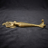 Full length solid brass mermaid double wall hook laid flat on dark background showing complete sculptural form from crown to double tail hooks — coastal mermaid decor handmade in Bali