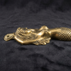 Three-quarter view of vintage solid brass mermaid double hook on dark background showing body curve tail and hook detail — brass mermaid drawer pull handmade in Ubud Bali
