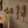 Set of 3 brass mermaid wall hooks mounted on a textured wall holding a towel, handmade coastal nautical coat hook set.