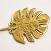 Detailed close up of brass monstera leaf wall hook showing texture and handcrafted finish