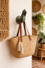 Brass mudra hand hook used as an entryway bag hook in a boho home decor setting.