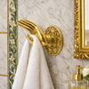 Solid brass mudra hand wall hook holding a towel in a spa bathroom—ideal as robe hook, towel hook, or decorative brass hardware.